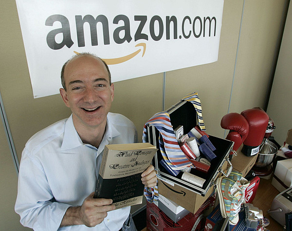 Основатель и генеральный директор Amazon Джефф Безос держит в руках экземпляр книги luid Concepts and Creative Analogies Дугласа Хофстадтера — первой книги, проданной на сайте Amazon.com, 17 июня 2005 годаAP/Ted S. Warren